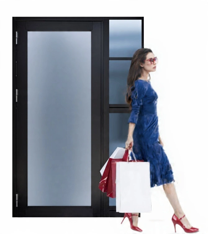 Woman with shopping bags walking past a black-framed frosted glass door.