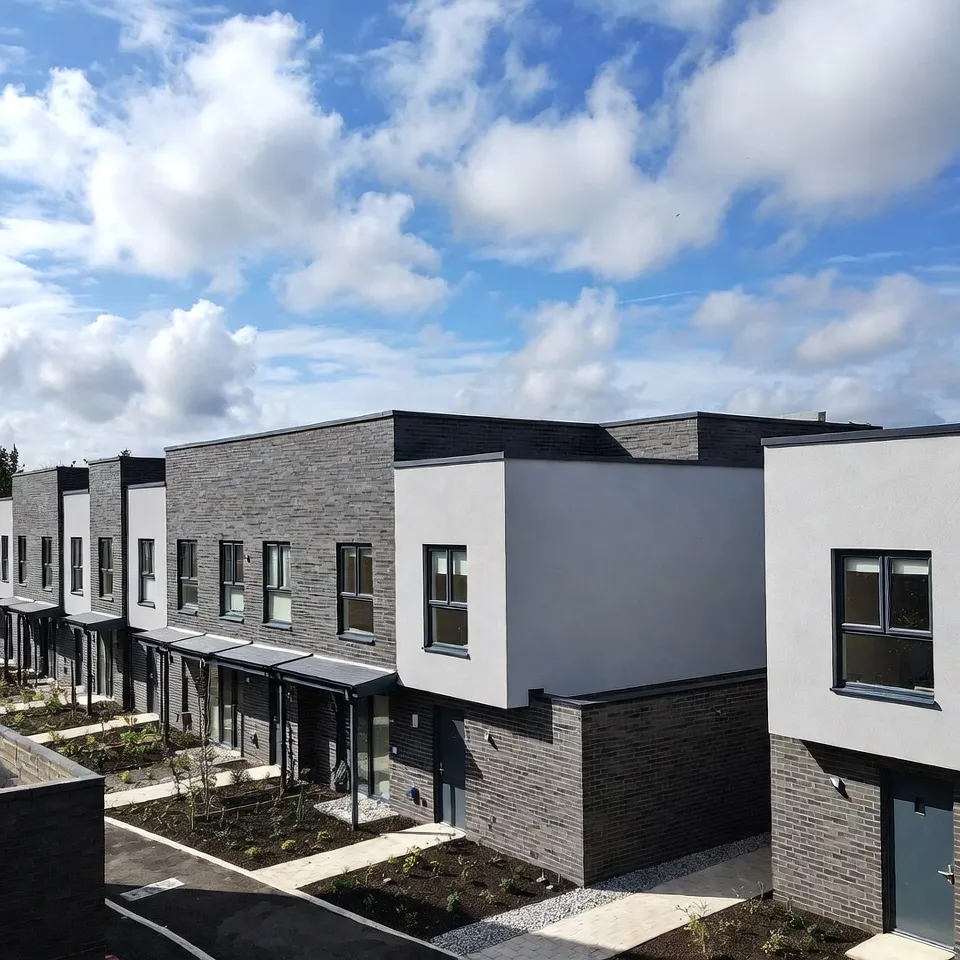 Modern townhouses with dark brick and gray facades.