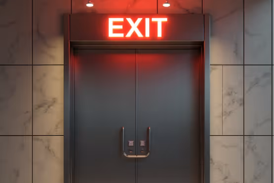  A prominent red "EXIT" sign illuminates a dark double door with silver handles, set against a tiled wall.